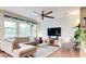 Spacious living room featuring a large window, hardwood floors, a ceiling fan, and a comfortable couch at 2090 Morro Vista Dr, Las Vegas, NV 89135