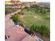 Bird's eye view of homes with pools near a golf course, set against mountains at 21 Avenida Sorrento, Henderson, NV 89011