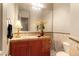 Well-lit bathroom with a large mirror, vanity, and neutral-toned tile at 21 Avenida Sorrento, Henderson, NV 89011