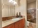 Well-lit bathroom showcasing a wooden vanity, decorative tile backsplash, and glass-enclosed shower at 21 Avenida Sorrento, Henderson, NV 89011