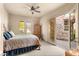 Bedroom with a ceiling fan and doors opening to an outdoor stone patio at 21 Avenida Sorrento, Henderson, NV 89011