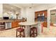 Well-equipped kitchen with a central island, granite counters, and stainless steel appliances at 21 Avenida Sorrento, Henderson, NV 89011