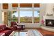 Bright living room with large windows showcasing mountain views and a cozy fireplace at 21 Avenida Sorrento, Henderson, NV 89011