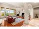 Bright and airy living room featuring a fireplace and access to the backyard at 21 Avenida Sorrento, Henderson, NV 89011