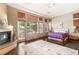 Serene main bedroom with a fireplace, natural light, and access to the outdoors at 21 Avenida Sorrento, Henderson, NV 89011