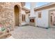 Private outdoor living area with a cozy fireplace and stone accents at 21 Avenida Sorrento, Henderson, NV 89011