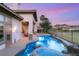 Sparkling pool with rock features, surrounded by lush landscaping and golf course views at 21 Avenida Sorrento, Henderson, NV 89011