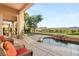 Covered patio boasts wicker furniture, a tranquil pool, and stunning views of the greenbelt at 21 Avenida Sorrento, Henderson, NV 89011