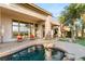 Home's rear exterior featuring a covered patio, pool, and well-manicured landscaping at 21 Avenida Sorrento, Henderson, NV 89011