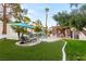 Expansive backyard with a waterfall pool, manicured lawn, and mature trees providing shade and privacy at 2101 Diamond Bar Dr, Las Vegas, NV 89117