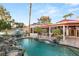 Stunning backyard showcasing a waterfall pool, multiple seating areas, and lush landscaping for serene outdoor living at 2101 Diamond Bar Dr, Las Vegas, NV 89117