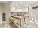Modern bar area with granite counters, barstool seating, ample cabinet space, and marble floors at 2101 Diamond Bar Dr, Las Vegas, NV 89117