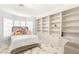 Bright bedroom featuring a cozy bed, plush pillows, and a custom built-in bookcase for ample storage at 2101 Diamond Bar Dr, Las Vegas, NV 89117