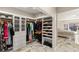 Walk-in closet with custom shelving, garment racks, and views into the main bedroom at 2101 Diamond Bar Dr, Las Vegas, NV 89117
