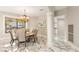 Charming dining room featuring a chandelier, marble floors, and views of the pool at 2101 Diamond Bar Dr, Las Vegas, NV 89117