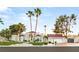 Elegant home featuring a red tile roof, lush landscaping, a circular driveway, and mature palm trees at 2101 Diamond Bar Dr, Las Vegas, NV 89117