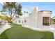 Charming home exterior with a well-manicured putting green, lush landscaping, and pristine white rock accents at 2101 Diamond Bar Dr, Las Vegas, NV 89117