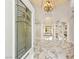 Grand foyer showcasing marble flooring, arched doorways, high ceilings, and an elegant chandelier at 2101 Diamond Bar Dr, Las Vegas, NV 89117