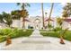 Stunning front exterior with a walkway, pristine lawn, manicured landscaping and mature palm trees at 2101 Diamond Bar Dr, Las Vegas, NV 89117