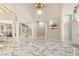 Bright open-concept living area featuring marble floors, arched doorways, and contemporary décor at 2101 Diamond Bar Dr, Las Vegas, NV 89117