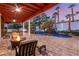 Relaxing outdoor patio featuring a fire pit and comfortable seating, overlooking a pool with a rock waterfall at 2101 Diamond Bar Dr, Las Vegas, NV 89117