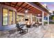 Covered patio with a fireplace, outdoor seating, and views of the backyard and pool at 2101 Diamond Bar Dr, Las Vegas, NV 89117