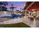 Stunning backyard features a custom pool, waterfall, outdoor kitchen, and covered patio seating at 2101 Diamond Bar Dr, Las Vegas, NV 89117