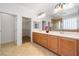 Bathroom featuring dual sinks, a spacious countertop, and walk-in closet at 2164 Sawtooth Mountain Dr, Henderson, NV 89044
