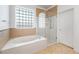 Modern bathroom featuring a soaking tub and glass-enclosed shower at 2164 Sawtooth Mountain Dr, Henderson, NV 89044