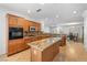 Well-lit kitchen with granite countertops, an island, stainless steel appliances, and wooden cabinetry at 2164 Sawtooth Mountain Dr, Henderson, NV 89044