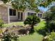 Lush backyard with artificial turf, mature landscaping, and a serene water feature at 2312 Indigo Island St, Henderson, NV 89044