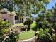 Backyard featuring artificial turf, mature landscaping, and a serene pond at 2312 Indigo Island St, Henderson, NV 89044