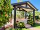 Outdoor covered patio with view of landscaped yard and mature trees at 2312 Indigo Island St, Henderson, NV 89044