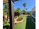 Lush backyard featuring artificial turf, a charming pond with rocks, and mature tropical landscaping at 2312 Indigo Island St, Henderson, NV 89044