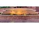 Stone sign for Santana community entrance featuring colorful flowers and manicured landscaping at 2312 Indigo Island St, Henderson, NV 89044