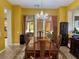 Elegant dining room with a large wooden table, chandelier, and stylish decor perfect for gatherings at 2312 Indigo Island St, Henderson, NV 89044