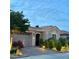 Inviting home exterior with a stone-accented entrance, manicured landscaping, and a two-car garage at 2312 Indigo Island St, Henderson, NV 89044