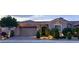 Charming home exterior with a well-manicured lawn, a three-car garage, and tasteful landscaping at 2312 Indigo Island St, Henderson, NV 89044
