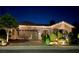 Charming single-story home with manicured landscaping and a spacious two-car garage, illuminated at night at 2312 Indigo Island St, Henderson, NV 89044