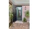 A welcoming glass-paneled front door with stylish accents and desert landscaping at 2312 Indigo Island St, Henderson, NV 89044