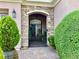 Close-up of the front gate with a stone archway and manicured shrubbery at the house entrance at 2312 Indigo Island St, Henderson, NV 89044