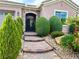 Charming home entrance with well-manicured landscaping and a welcoming stone-accented archway at 2312 Indigo Island St, Henderson, NV 89044
