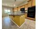 Kitchen island with breakfast bar, sink, and ample counter space at 2312 Indigo Island St, Henderson, NV 89044