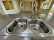Close up of kitchen sink and tile flooring at 2312 Indigo Island St, Henderson, NV 89044