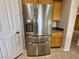Modern kitchen with stainless steel fridge and oak cabinets at 2312 Indigo Island St, Henderson, NV 89044