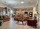 Bright, open living room with tile floors, comfortable seating, and seamless access to the dining area at 2312 Indigo Island St, Henderson, NV 89044