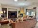 Spacious living room with a fireplace, ample seating, and an open layout perfect for entertaining at 2312 Indigo Island St, Henderson, NV 89044