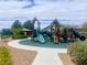 Community playground equipment with slides and climbing structures, surrounded by a walking path and landscaping at 2312 Indigo Island St, Henderson, NV 89044