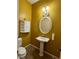 A stylish powder room features a pedestal sink, decorative mirror, and charming wall decor at 2312 Indigo Island St, Henderson, NV 89044