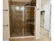 Walk-in shower with tiled walls and clear glass doors and a view of a walk-in closet at 2312 Indigo Island St, Henderson, NV 89044